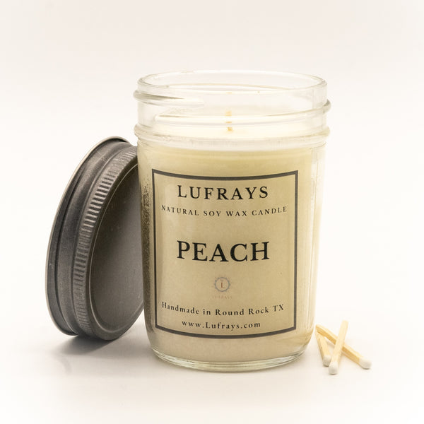 Handmade peach soy candle in 8oz jelly jar with pewter lid.