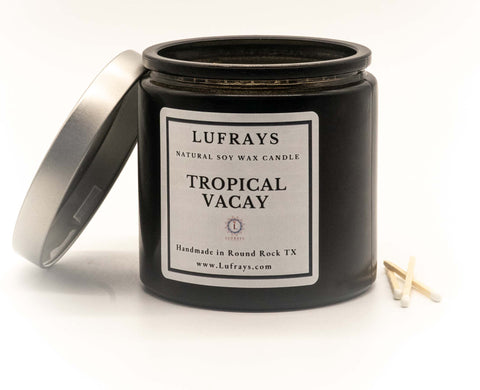 Handmade two wick soy candle in black jar with silver lid in Tropical Vacay fragrance.