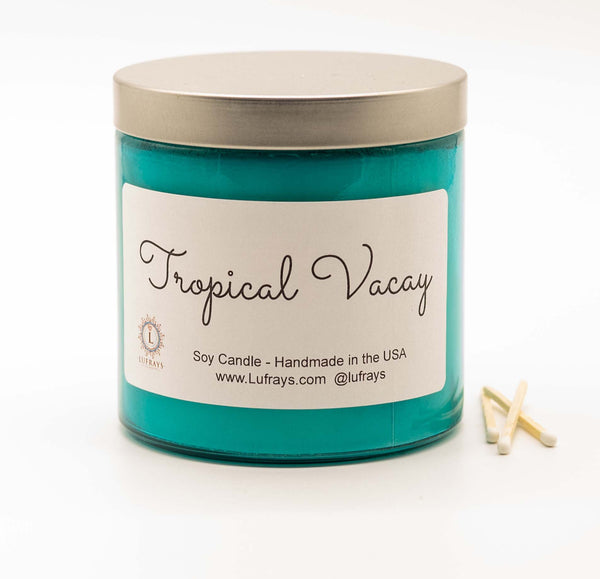 Handmade two wick soy candle in turquoise jar with silver lid in Tropical Vacay fragrance.